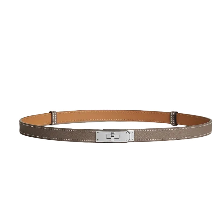 A slim leather belt in taupe with a tan interior lining and a silver-toned metal buckle.